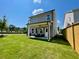 Large, level backyard with green grass and a covered patio area, great for outdoor entertaining and relaxing at 120 Winsome Way, Woodstock, GA 30188