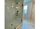 Glass enclosed shower with white tiling and a window for natural light at 120 Winsome Way, Woodstock, GA 30188