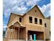 New home under construction with visible framing, siding, and windows, with neighborhood visible at 120 Winsome Way, Woodstock, GA 30188