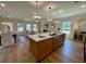 Open concept kitchen with a large island, pendant lighting, stainless steel appliances, and an adjacent dining area at 120 Winsome Way, Woodstock, GA 30188