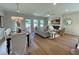 Open-concept living room and dining area with modern furnishings and ample natural light at 120 Winsome Way, Woodstock, GA 30188