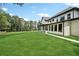 A well-maintained backyard view of the home with a covered patio and outdoor kitchen at 4292 Sardis Church Rd, Buford, GA 30519