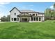 Expansive backyard view showcasing the home's outdoor kitchen and covered patio at 4292 Sardis Church Rd, Buford, GA 30519