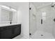 Modern bathroom with marble tiled walk-in shower, matte black fixtures, and vanity with undermount sink at 4292 Sardis Church Rd, Buford, GA 30519