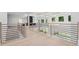 Upstairs hallway with black metal railings overlooking the living room and backyard at 4292 Sardis Church Rd, Buford, GA 30519