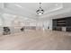 Large hallway with tray ceiling, hardwood floors, and a built in bar at 4292 Sardis Church Rd, Buford, GA 30519