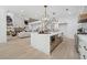 Open-concept kitchen with a large island seamlessly connected to the living area at 4292 Sardis Church Rd, Buford, GA 30519