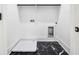 Well-lit laundry room featuring black marble floors, crisp white walls, and laundry connections at 4292 Sardis Church Rd, Buford, GA 30519