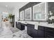 Bathroom featuring marble floors, quartz countertops and a vanity with three lighted mirrors at 4292 Sardis Church Rd, Buford, GA 30519