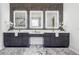 Bathroom featuring marble floors, quartz countertops and a vanity with three lighted mirrors at 4292 Sardis Church Rd, Buford, GA 30519