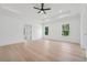 Bright main bedroom featuring hardwood floors, tray ceiling, recessed lighting, and natural light from two windows at 4292 Sardis Church Rd, Buford, GA 30519