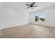 Bright main bedroom featuring hardwood floors and natural light from a large window with backyard view at 4292 Sardis Church Rd, Buford, GA 30519