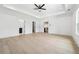 Spacious main bedroom featuring hardwood floors, tray ceiling, and doors to bathroom and closets at 4292 Sardis Church Rd, Buford, GA 30519