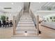 Staircase with wood treads, sleek metal railings, and open sightlines to living spaces at 4292 Sardis Church Rd, Buford, GA 30519