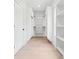 Spacious walk-in closet with custom white shelving and storage, providing ample space for organization at 4292 Sardis Church Rd, Buford, GA 30519