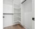 White walk-in closet featuring custom shelving and drawers providing ample storage space at 4292 Sardis Church Rd, Buford, GA 30519