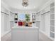 A walk-in closet with a center island, white cabinets and countertops at 4292 Sardis Church Rd, Buford, GA 30519