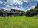 Spacious backyard featuring a large grassy area and partial privacy provided by trees at 8170 Canyon Forge Dr, Riverdale, GA 30274
