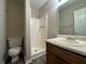 This bathroom features a walk-in shower, white toilet, and marble sink at 8170 Canyon Forge Dr, Riverdale, GA 30274