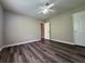 This bedroom features new wood floors and a white door at 8170 Canyon Forge Dr, Riverdale, GA 30274