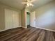 This bedroom features new wood floors, a ceiling fan, and a closet at 8170 Canyon Forge Dr, Riverdale, GA 30274