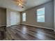 This bedroom features new wood floors, a ceiling fan, and two windows with natural light at 8170 Canyon Forge Dr, Riverdale, GA 30274