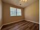 This bedroom features new wood floors and a window with natural light at 8170 Canyon Forge Dr, Riverdale, GA 30274