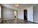 Bedroom featuring wood floors, ceiling fan, and doorway leading to the bathroom at 8170 Canyon Forge Dr, Riverdale, GA 30274