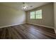 This bedroom features new wood floors, a ceiling fan, and a window with natural light at 8170 Canyon Forge Dr, Riverdale, GA 30274