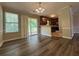Inviting dining area featuring wood floors and sliding doors with view into kitchen at 8170 Canyon Forge Dr, Riverdale, GA 30274