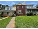 Charming two-story townhome with brick facade and inviting front entrance, surrounded by lush landscaping at 8170 Canyon Forge Dr, Riverdale, GA 30274