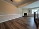 Bright living room with wood floors, fireplace, and staircase to upper floors at 8170 Canyon Forge Dr, Riverdale, GA 30274