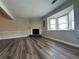 Bright living room with wood floors, fireplace, and a large window letting in natural light at 8170 Canyon Forge Dr, Riverdale, GA 30274