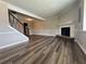 Living room view featuring wood floors, a cozy fireplace, and staircase access to the upper level at 8170 Canyon Forge Dr, Riverdale, GA 30274