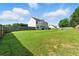 Expansive, fully-fenced backyard featuring lush green lawn and two-story home with vinyl siding at 150 Crestworth Xing, Powder Springs, GA 30127