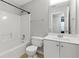 Well-lit bathroom featuring a bathtub, toilet, and vanity with neutral tile floors at 150 Crestworth Xing, Powder Springs, GA 30127
