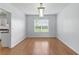 Bright dining room with hardwood floors and modern light fixture at 150 Crestworth Xing, Powder Springs, GA 30127