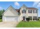 Charming two-story home with an attached two-car garage, manicured lawn, and classic shuttered windows at 150 Crestworth Xing, Powder Springs, GA 30127