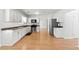 Well-lit kitchen with stainless steel appliances, white cabinets, and hardwood floors at 150 Crestworth Xing, Powder Springs, GA 30127