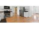 Modern kitchen with stainless steel appliances, white cabinets, and hardwood floors with barn door feature at 150 Crestworth Xing, Powder Springs, GA 30127