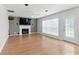 Open living room features a fireplace, hardwood floors, and large windows for natural light at 150 Crestworth Xing, Powder Springs, GA 30127