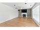 Bright living room features a fireplace, hardwood floors, large windows and access to a doorway at 150 Crestworth Xing, Powder Springs, GA 30127