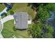 Aerial view of a home with a gray roof surrounded by lush greenery and a serene lake at 297 Aylesbury Blvd, Mcdonough, GA 30252