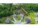 Aerial view showcases a cul-de-sac homes surrounded by dense trees and a tranquil pond at 297 Aylesbury Blvd, Mcdonough, GA 30252