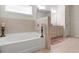 Soaking tub in bathroom featuring decorative candles and modern faucets at 297 Aylesbury Blvd, Mcdonough, GA 30252