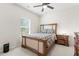 Bedroom features a charming wooden bed frame and light-filled window at 297 Aylesbury Blvd, Mcdonough, GA 30252