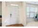Entryway featuring a white front door, adjacent to a bright window and a plant at 297 Aylesbury Blvd, Mcdonough, GA 30252