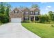 Beautiful two-story brick home with a well-manicured lawn and driveway at 297 Aylesbury Blvd, Mcdonough, GA 30252