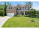 Charming two-story brick home with well-manicured lawn and attached two-car garage at 297 Aylesbury Blvd, Mcdonough, GA 30252