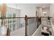 Bright hallway with wood railings and views of the lower level living space at 297 Aylesbury Blvd, Mcdonough, GA 30252